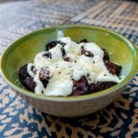 Platanos Y Crema · Sweet plantains, Mexican crema, and queso fresco.