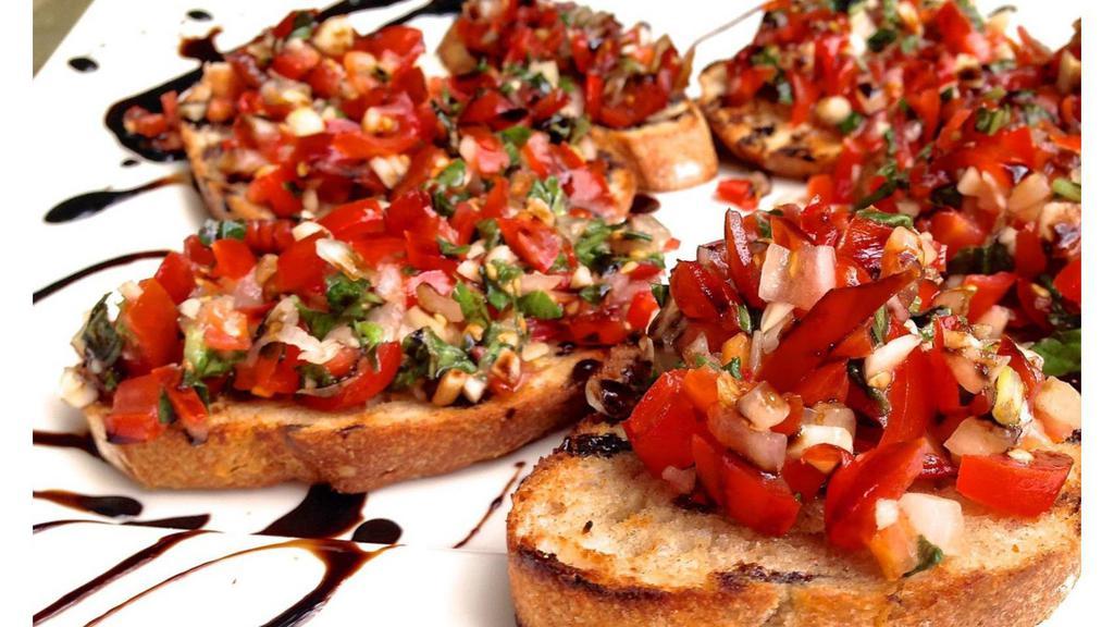 Bruschetta Crostini · Garlic Toast topped with diced Tomatoes, Onion, and Basil | finished with a Balsamic Demi-glace & dusted with Grated Parmesan (4 per order)
