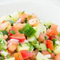Shepherd Salad · Tomatoes, cucumbers, parsley, onions, green peppers, olive oil and red vinegar, lemon juice.
