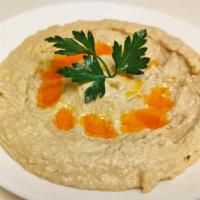 Hummus · Mashed chickpeas blended with tahini, cumin, garlic, olive oil and lemon.