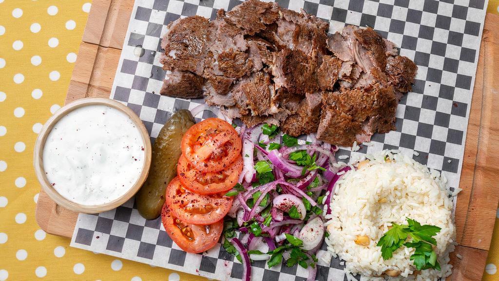 Lamb Gyro Plater · Traditionally made with beef&lamb meat and grilled on a vertical spit of stacked meat slices served with rice, tzatzki, onion, grilled pepper and tomato.