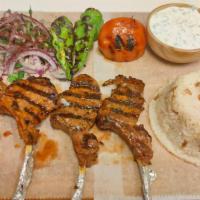 Lamb Chops · Cuts of lamb which are traditionally marinated and grilled, served with rice, cacik, onion w...