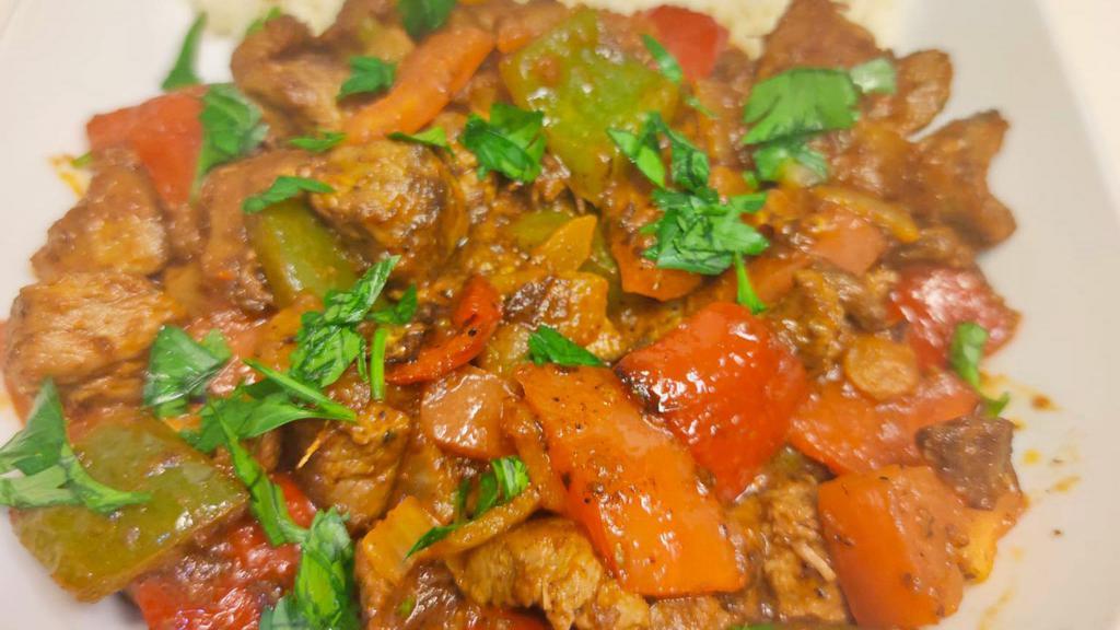 Lamp Saute · Sauteed lamb cubes with onion, tomato, green and red pepper served with rice.