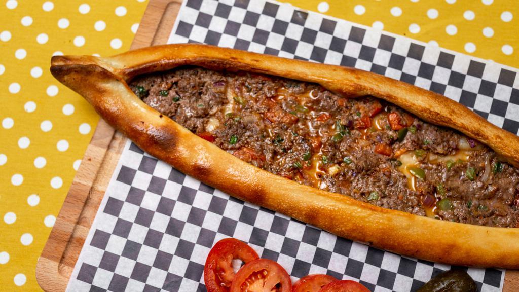 Ground Beef Pita · Traditional style Turkish Pizza with ground beef blended with onion, tomato, green and red pepper.