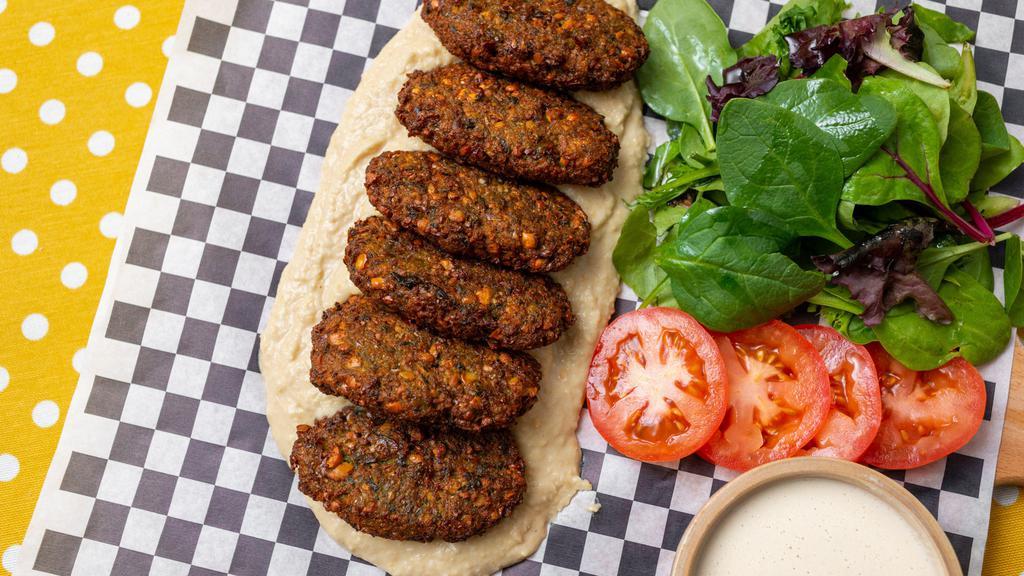 Falafel Dinner · Six pieces falafel served with hummus, greens, tomatoes and tahini sauces.