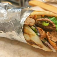 Lamb Gyro Wrap · Traditionally made with lamb & beef and grilled on a vertical spit of stacked meat slices.