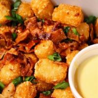 Loaded Tater Tots · homemade cheese sauce, crumbled bacon, spicy ranch, & scallions