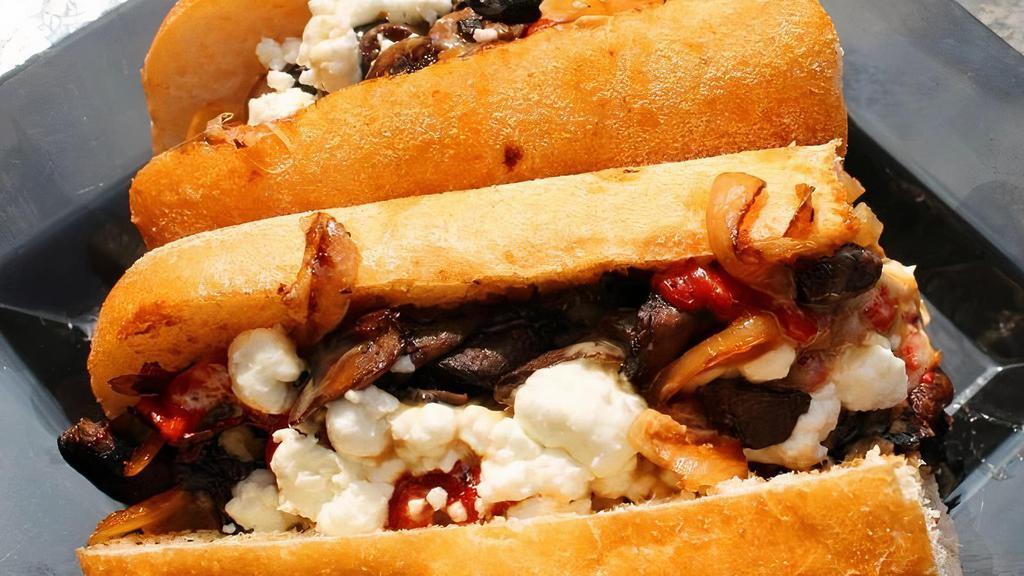 Moo-Shroom Veggie · provolone & goat cheese, oven roasted portobello & white mushrooms, red peppers, caramelized onions, & porcini sauce