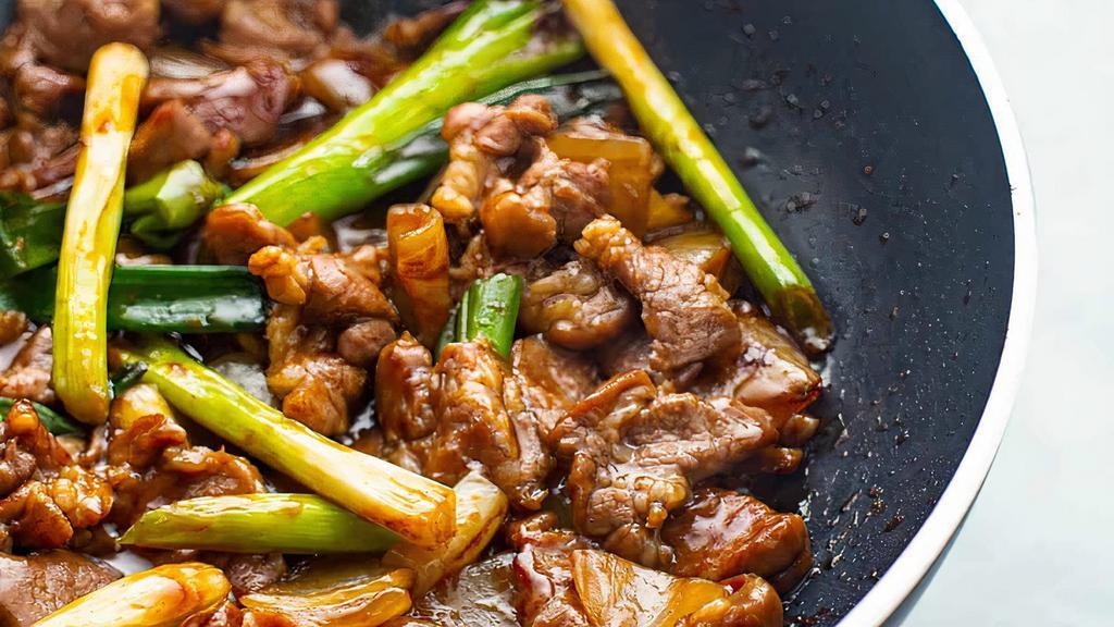 Mongolian Lamb 蒙古羊 · Stir fried with thin slices of Lamb simmered scallion, snow peas in a soy, brown sugar, garlic and ginger sauce