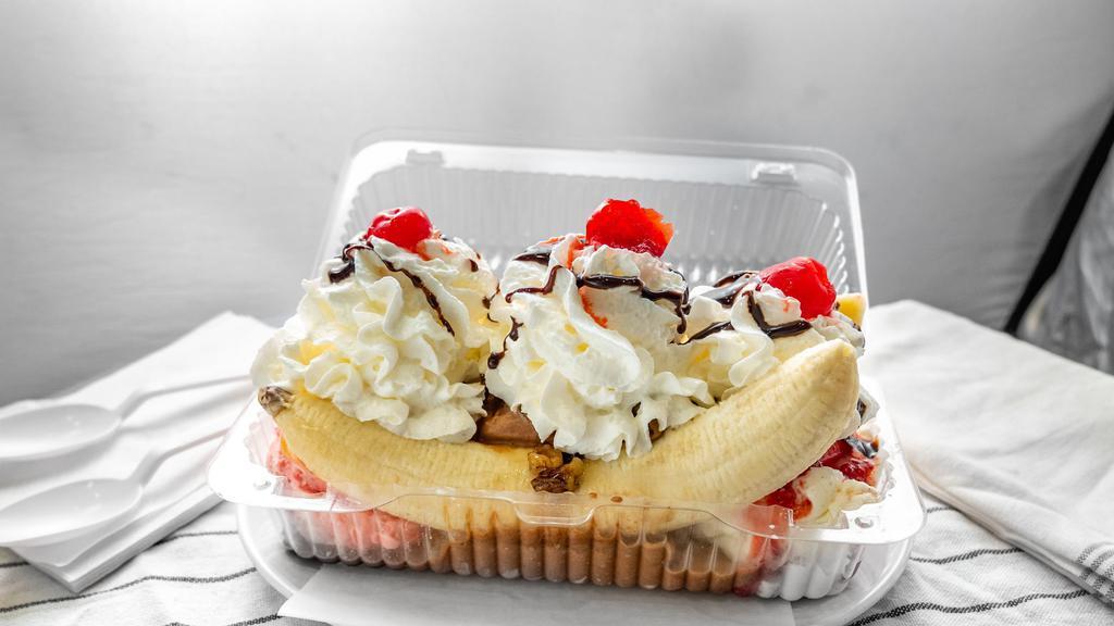 Traditional Banana Split Sundae With Custard Ice Cream · Choice of 3 flavored ice cream, comes with strawberries, pineapples, wet walnuts, chocolate syrup, whipped cream and a cherry.