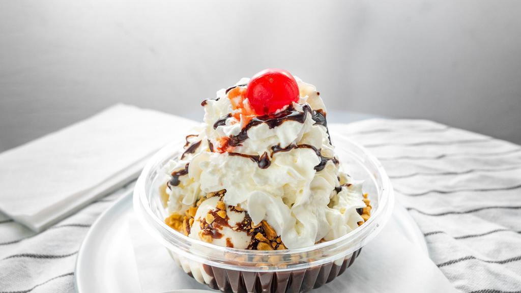 Hot Fudge Brownie Sundae With Custard Ice Cream · Vanilla ice cream, hot fudge, sliced brownies, whipped cream and a cherry. Add brownie for an additional charge.