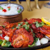 Tandoori Chicken · Chicken leg marinated with yogurt, ginger,garlic, and other Indian spices baked in tandoor o...