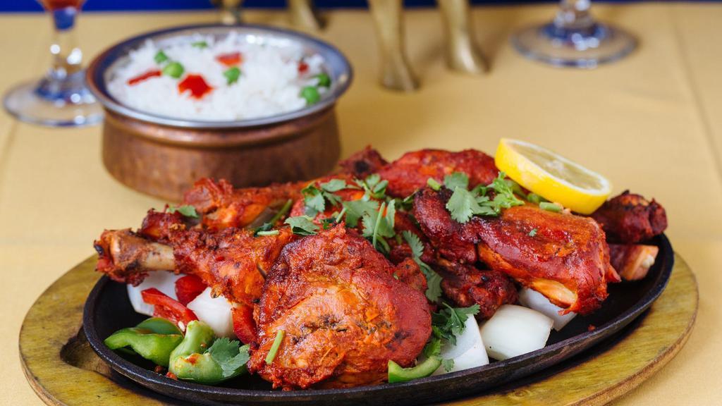 Tandoori Chicken · Chicken leg marinated with yogurt, ginger,garlic, and other Indian spices baked in tandoor oven.
