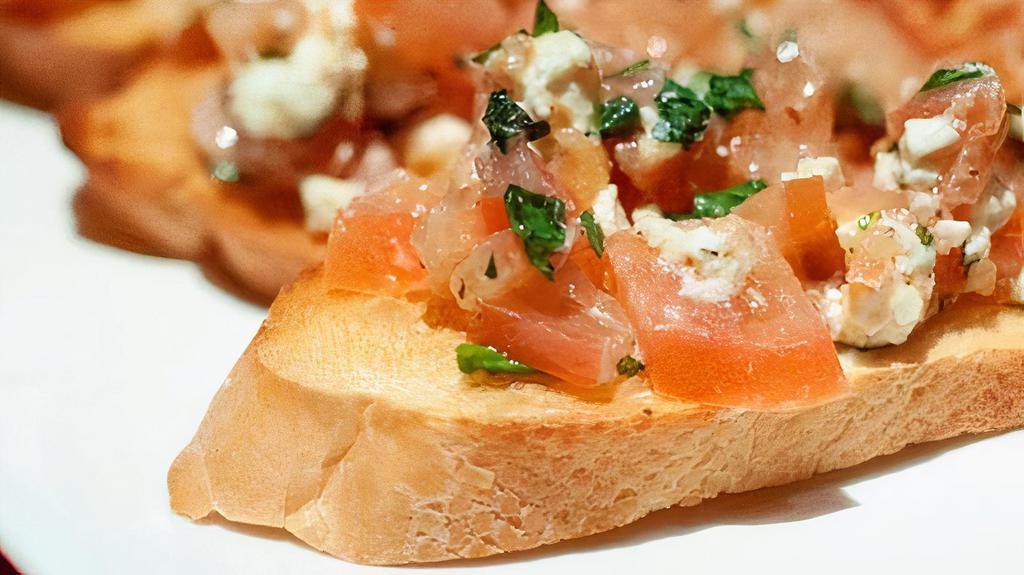 Bruschetta · Feta, tomatoes, fresh garlic, olive oil and herbs over toasted French bread.