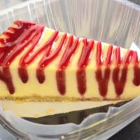 Raspberry Cheesecake Slice · New York style cheesecake topped with Raspberry sauce.