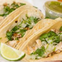Tacos · Three corn tacos, cilantro, onions, and lemon and green sauce on the side. Meat must be added.