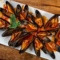 Mussels Linguine · Steamed mussels in tomato sauce, white wine, clam juice over pasta.