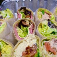 Grilled Chicken Club Wrap · Marinated chicken tenders, bacon, fresh lettuce, tomatoes and homemade Greek dressing. Serve...