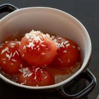 Gulab Jamun · Fried dumplings made of thickened milk and soaked in rose flavored syrup.