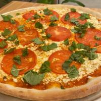 Greek Pizza · with Red Sauce, Feta Cheese, Tomatoes, Olive Oil, Basil and Daily Fresh Dough. Choice of size.
