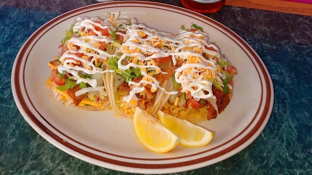 Fish Tacos (3) · Fresh Fried Fish served in a corn tortilla with rice, lettuce, pico de gallo  and house dressing.