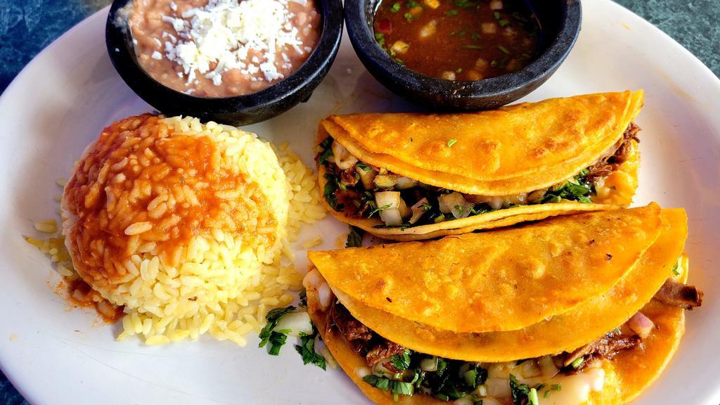 Beef Birria Quesadilla Dinner · Two delicious cheese quesadillas stuffed with our delicious beef birria. Served with rice and beans.