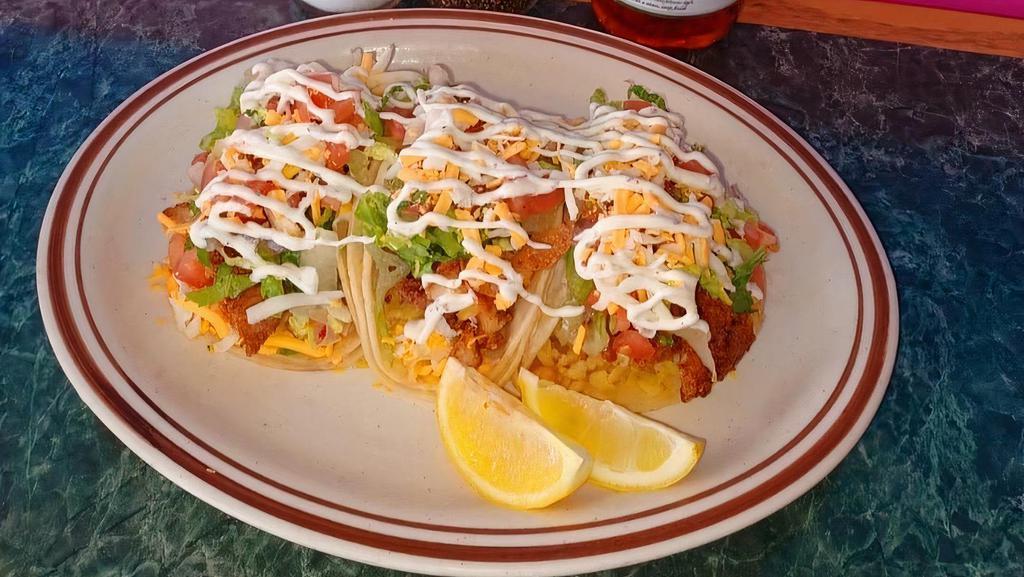 Fish Taco Dinner · Fresh fried fish, served on a corn tortilla with rice, pico de gallo, house dressing and cheese. Served with rice, beans and small salad.