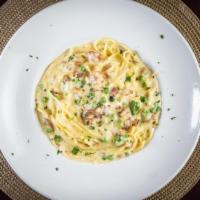 Linguine Carbonara · Linguine pasta in a traditional carbonara sauce. Made with pancetta, onions, green peas, egg...