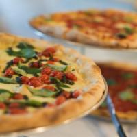 Capri Pizza (W) · Fresh mozzarella, tomatoes, and basil with pesto drizzle.
