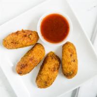 Aloo Tikki · Flavorful potatoes patties, deep fried in chick-pea batter.