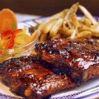 Bbq Pork Ribs · Dry-rubbed spare ribs topped with our BBQ sauce. Your choice of 2 sides.