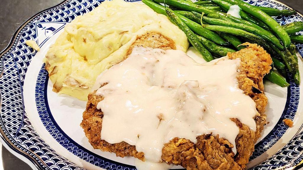 Chicken Fried Steak · Seasoned, breaded, and fried sirloin steak with a side of white gravy. Served with mashed potatoes and green beans.