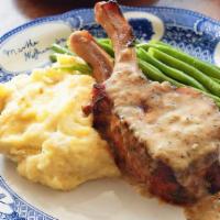 Long-Roasted Pork Chop · Braised with herbs and topped with peppercorn gravy. Served with your choice of two sides.