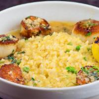 Scallops Meunière · Scallops sautéed to perfection with butter, shallots, garlic, and lemon. Served over buttern...