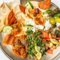 Mediterranean Combo Platter (Mazza) · Hummus, baba ghanouj, tabbouleh, Moroccan eggplant, falafel balls, tomato cucumber salad, ca...