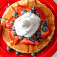 All American Pancakes · 3 With fresh strawberries, blueberries and whipped cream.