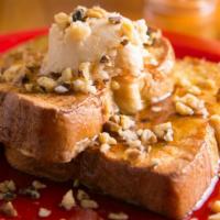 Maple Walnut French Toast (3) · 3 French toast topped with chopped walnuts and maple butter.