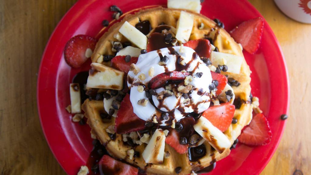 Banana Split Waffle · Sliced bananas, pineapple, strawberries, topped with walnuts, whipped cream and chocolate syrup.