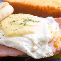 Benny Boy · Egg benedict sandwich with over-easy egg, ham and hollandaise sauce. Shown with one side not...