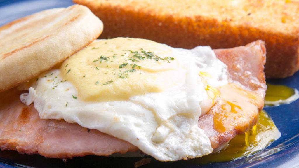 Benny Boy · Egg benedict sandwich with over-easy egg, ham and hollandaise sauce. Shown with one side not included.