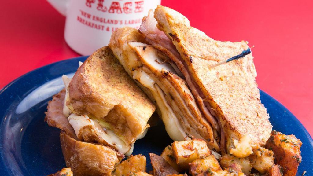 Monte Cristo · Ham, turkey and melted cheese between two slices of French toast. Shown with one side not included.