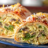Mexican Burrito · A flour tortilla folded and rolled. Filled with scrambled eggs, green peppers, onions, mushr...