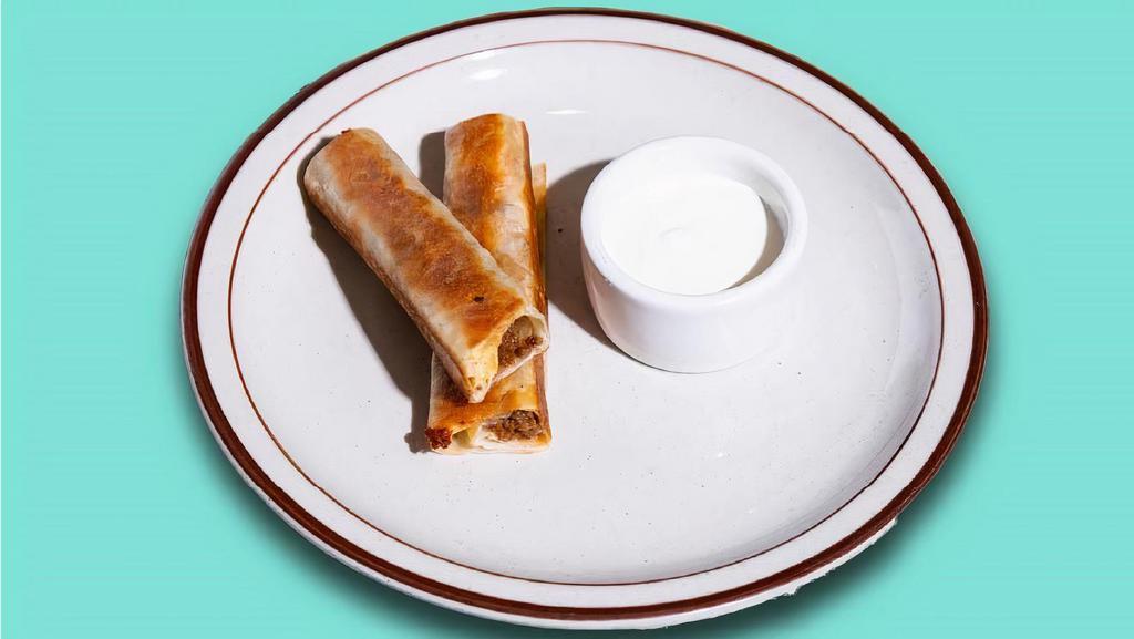 Kid'S Rolled Quesadilla · Choice of chicken or ground beef. Two crisped flour tortillas, cheddar cheese, side of crema.