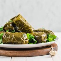 Dolma · Fresh grape leaves filled with seasoned rice.
