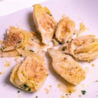 Carciofo · Oven roasted artichoke hearts parmesan bread chumb seasoned, and herb oil drizzle.