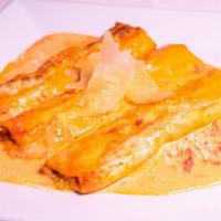 Cannelloni · House-made pasta crepe, spinach, and ricotta cheese filling blush tomato cream sauce.
(handm...