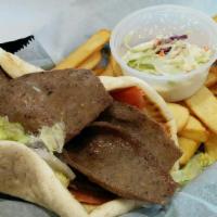 Gyro Platter · Gyro sandwich with tzatziki sauce, lettuce, tomato, raw onions, french fries, and coleslaw.