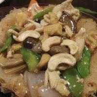 Buddhist Yam Pot · Shaped fried taro stuffed with corn, snow peas and black mushroom, topped with cashew nuts.