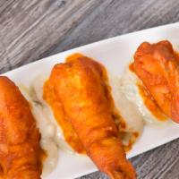 Buffalo Shrimp · Wild caught baja shrimp tossed with a spicy or mild sauce and served with a creamy roquefort...