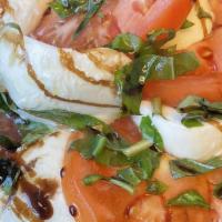 Caprese · Fresh mozzarella, tomatoes, green basil, seasoned with salt and olive oil.